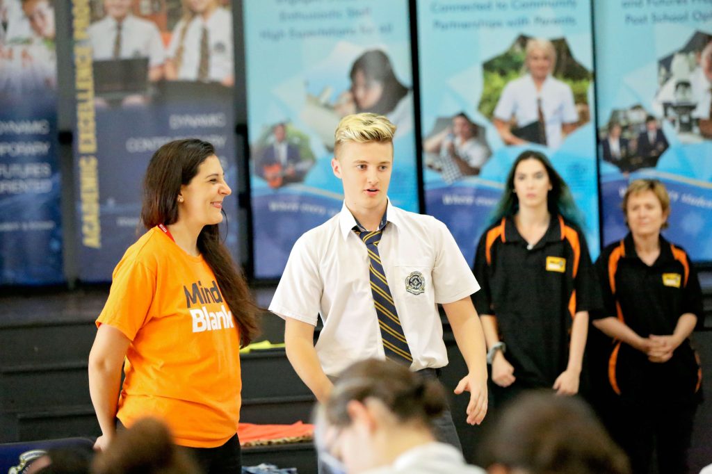 A student performs during an interactive school mental health program.